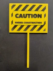 Craft material and supply: Caution Under Construction cake topper